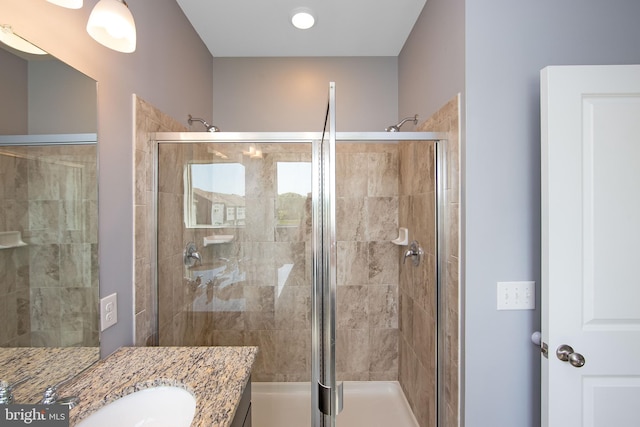 bathroom featuring vanity and a stall shower