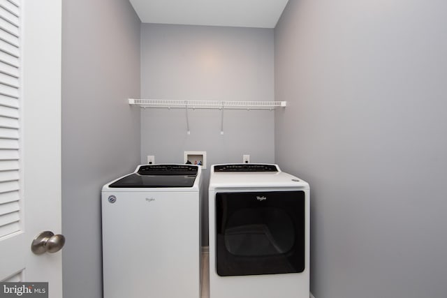 laundry area featuring separate washer and dryer and laundry area