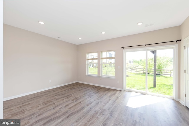 interior space featuring recessed lighting, baseboards, visible vents, and light wood-style flooring