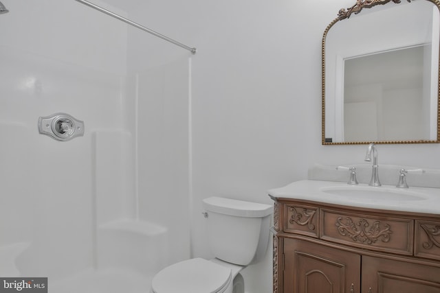 full bath with vanity, walk in shower, and toilet