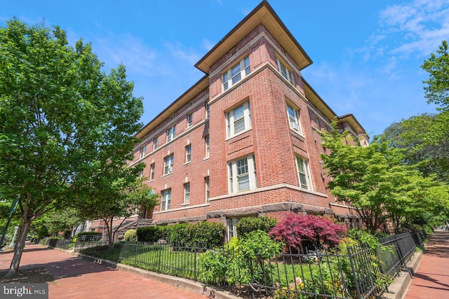 view of building exterior featuring fence private yard