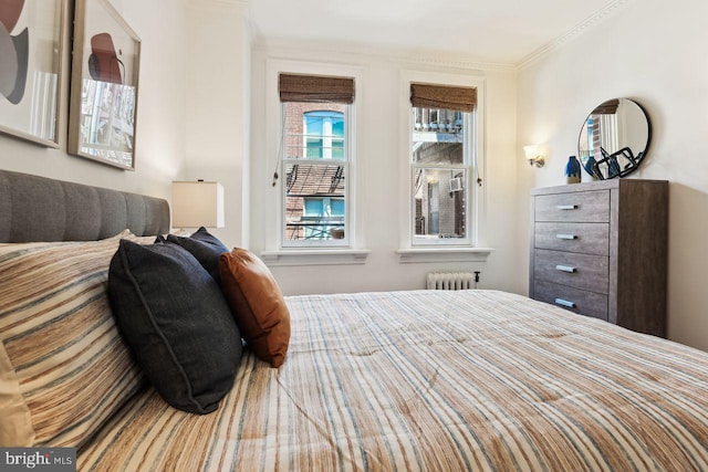 bedroom featuring crown molding and radiator heating unit