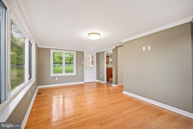 2115 Pennington, Ewing, NJ 08638 - empty room featuring ornamental molding, light wood-style flooring, baseboards, and healthy amount of natural light