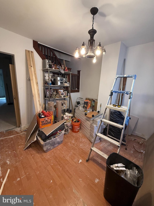 dining area with a chandelier and wood finished floors