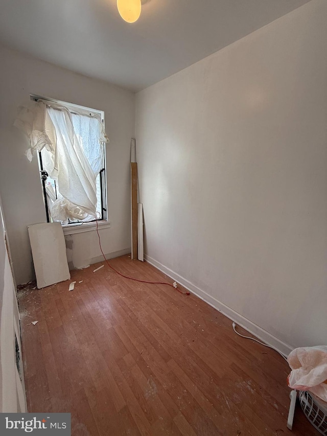 unfurnished room with light wood-style floors and baseboards