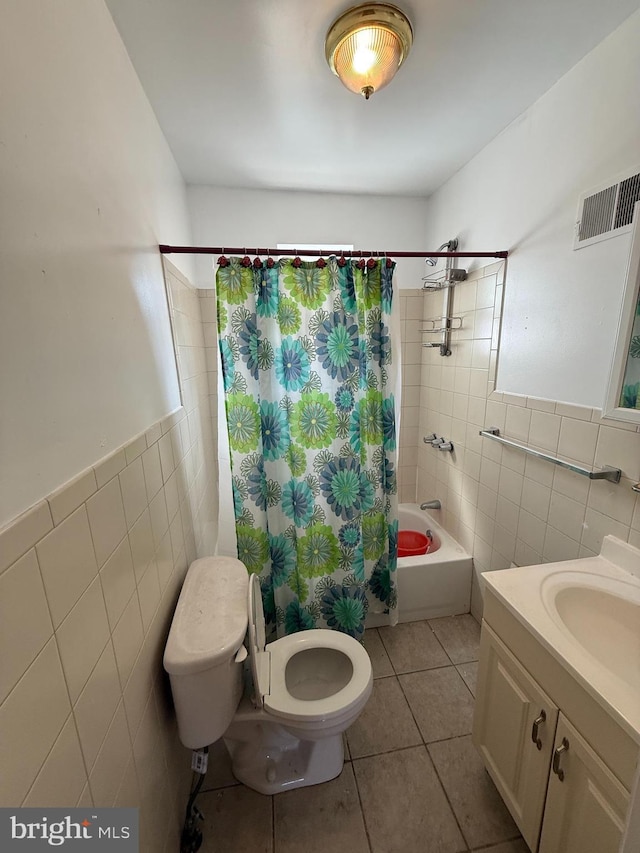 bathroom with visible vents, toilet, tile walls, shower / bathtub combination with curtain, and tile patterned floors