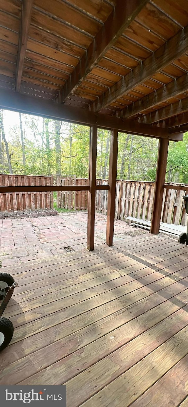 wooden terrace featuring fence