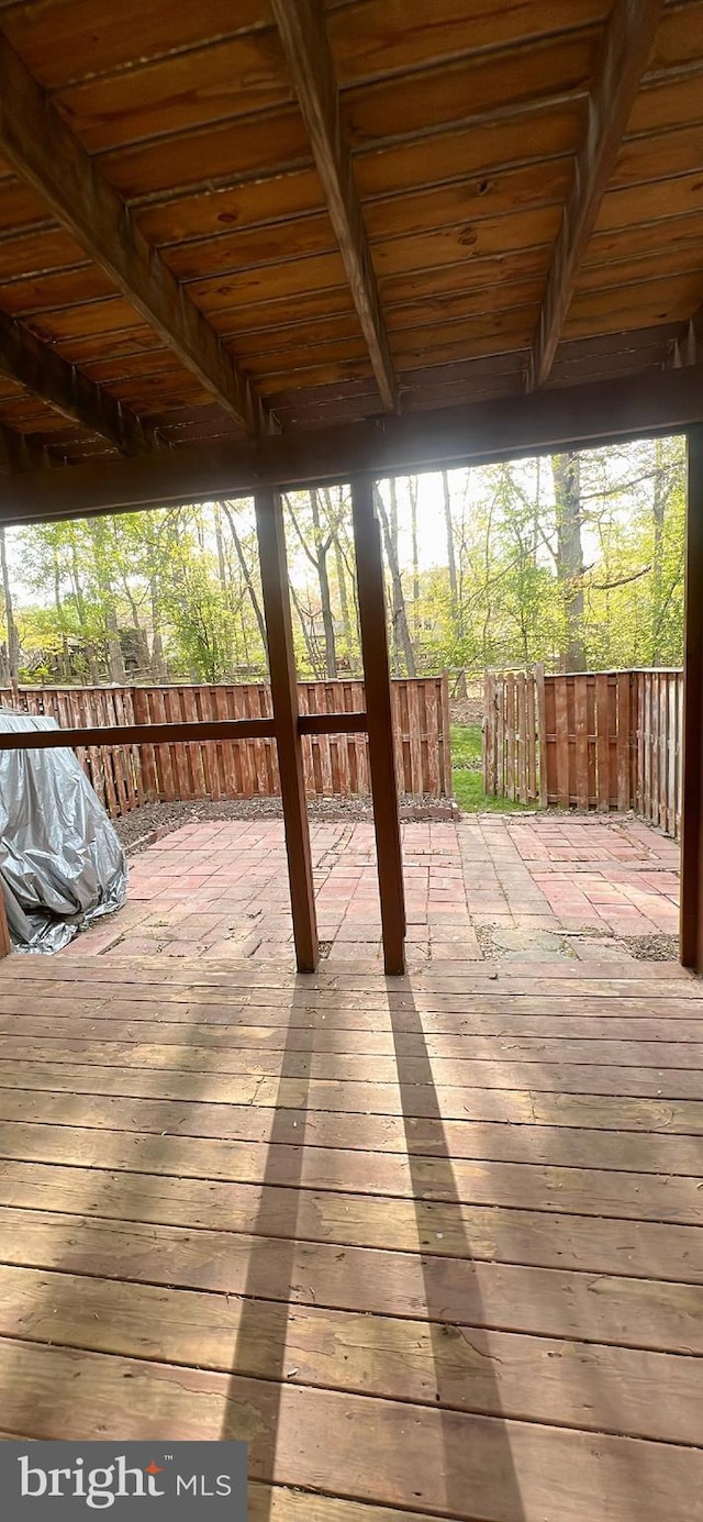 wooden terrace featuring fence