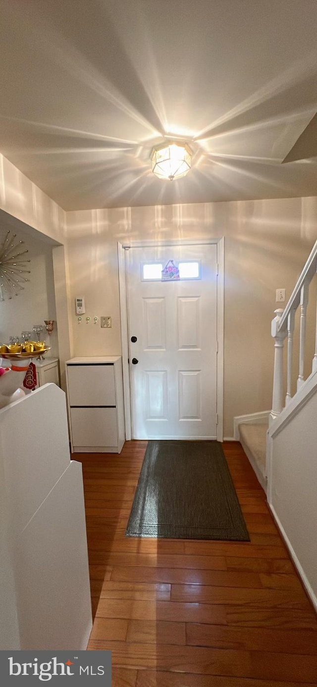 foyer with wood-type flooring and stairway