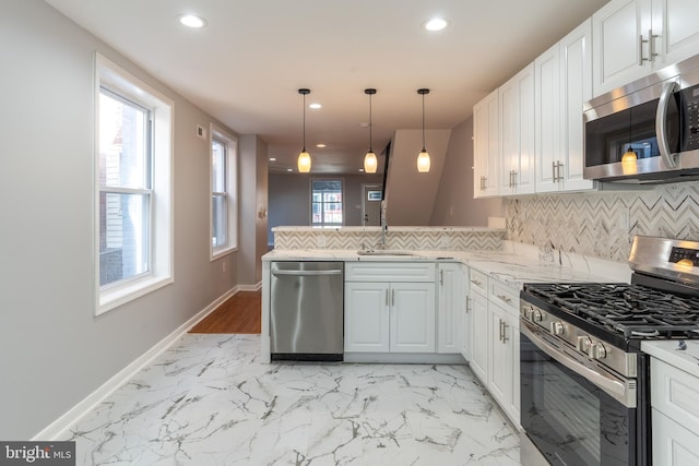 kitchen featuring decorative backsplash, a sink, stainless steel appliances, recessed lighting, and white cabinetry