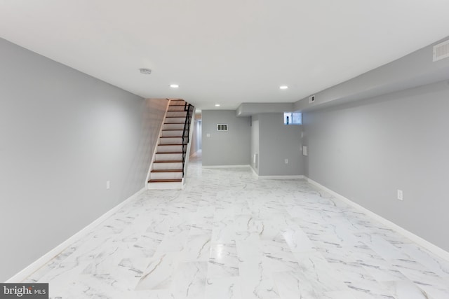 finished below grade area featuring recessed lighting, baseboards, and stairway