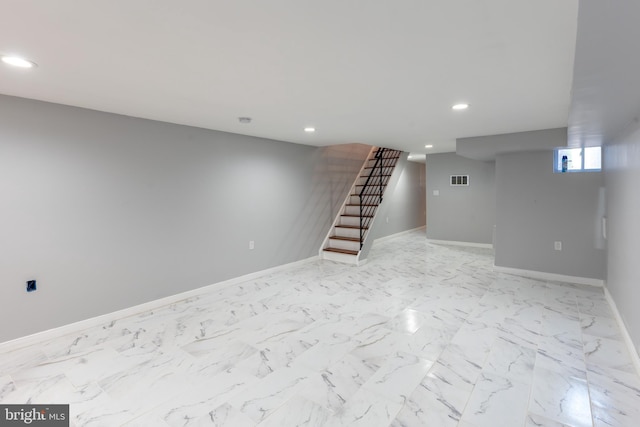 below grade area with stairs, recessed lighting, and baseboards