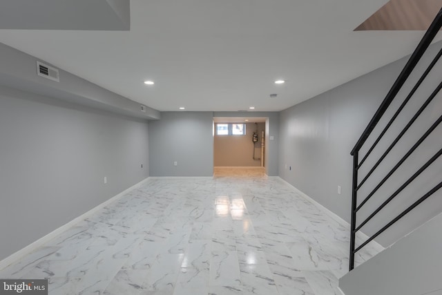 below grade area with stairway, marble finish floor, recessed lighting, and visible vents