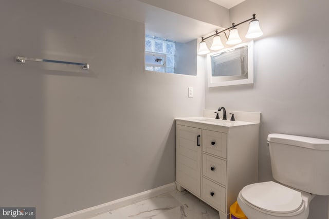 half bath featuring toilet, baseboards, marble finish floor, and vanity