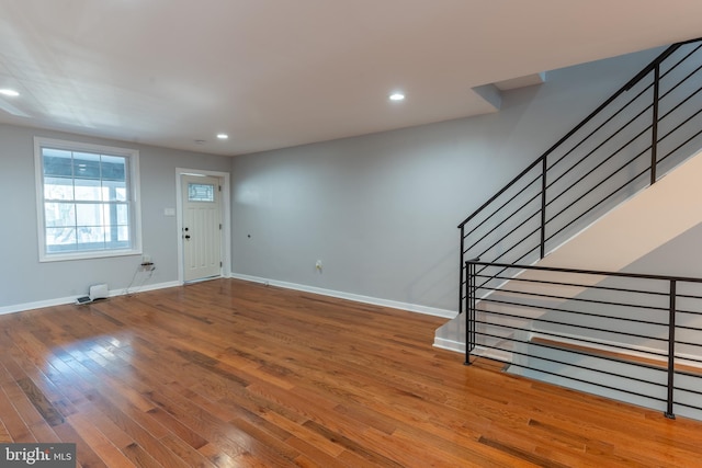 foyer entrance with stairs, recessed lighting, baseboards, and wood finished floors