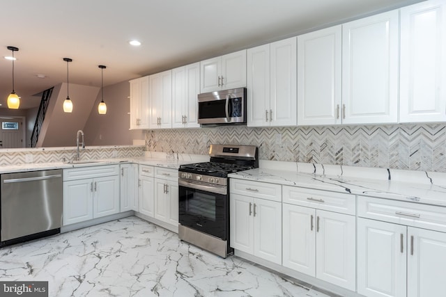 kitchen with a sink, light stone counters, stainless steel appliances, and marble finish floor