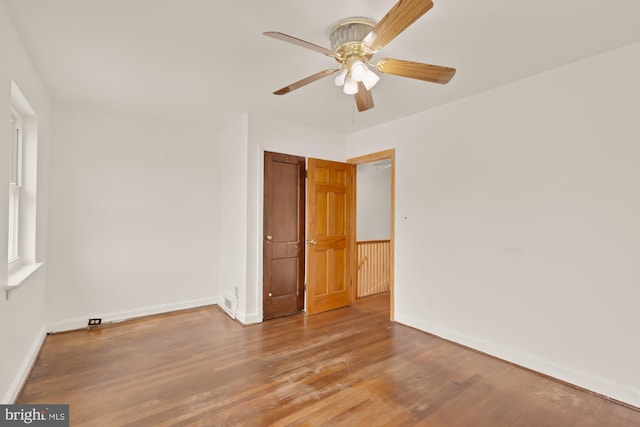 unfurnished bedroom with baseboards, ceiling fan, a closet, and wood finished floors