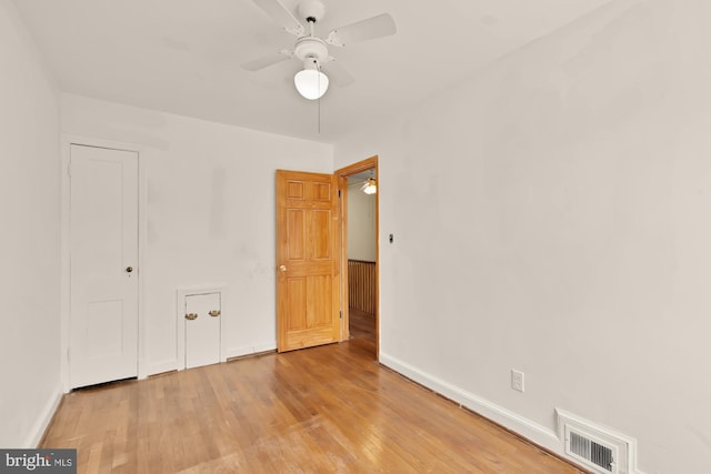 unfurnished bedroom with baseboards, a ceiling fan, light wood-type flooring, and visible vents