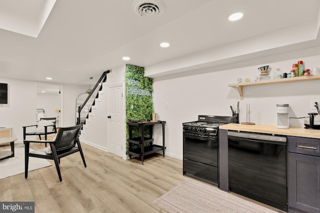 kitchen featuring recessed lighting, baseboards, black appliances, and light wood finished floors