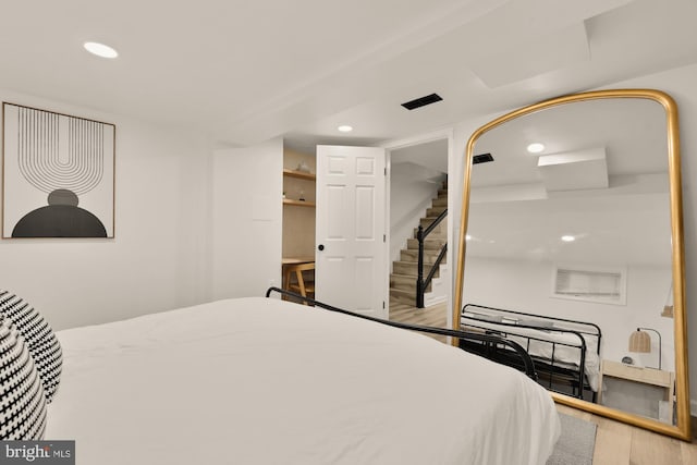 bedroom featuring recessed lighting and wood finished floors