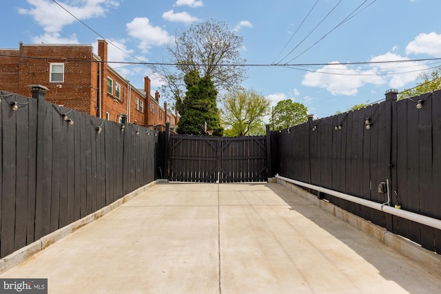 view of patio featuring a fenced backyard and a gate