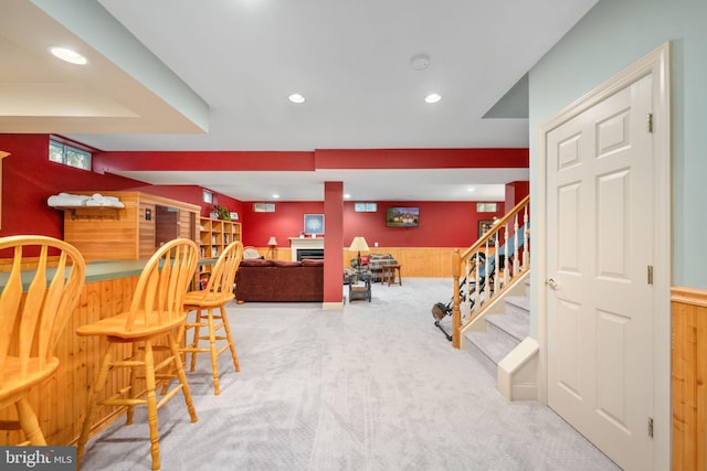 13073 Taverner Loop, Woodbridge, VA 22192 - carpeted dining space with wooden walls, stairway, recessed lighting, a wainscoted wall, and bar area