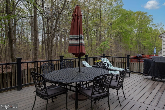 13073 Taverner Loop, Woodbridge, VA 22192 - wooden terrace featuring a wooded view and outdoor dining space