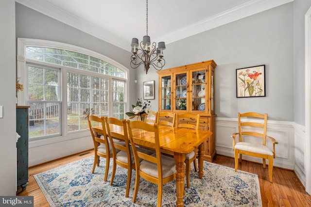13073 Taverner Loop, Woodbridge, VA 22192 - dining room with an inviting chandelier, light wood finished floors, and plenty of natural light