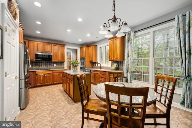 13073 Taverner Loop, Woodbridge, VA 22192 - kitchen with an inviting chandelier, decorative backsplash, recessed lighting, a sink, and appliances with stainless steel finishes