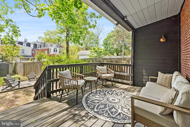 228 Morgan St, Phoenixville, PA 19460 - wooden deck with outdoor lounge area, fence, a shed, an outbuilding, and a residential view