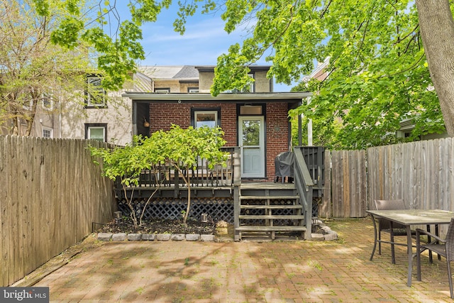 228 Morgan St, Phoenixville, PA 19460 - back of house with brick siding, a fenced backyard, a patio area, and a wooden deck
