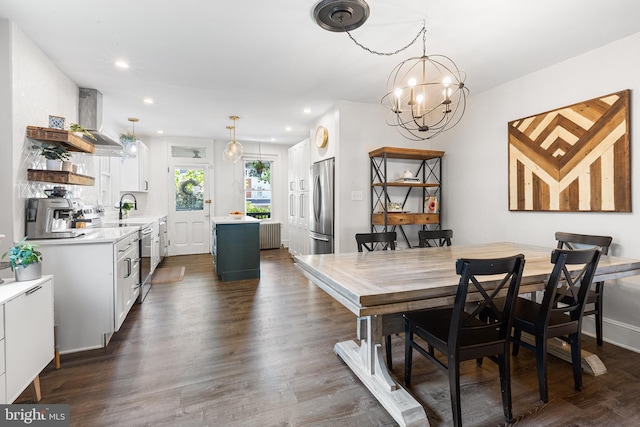 228 Morgan St, Phoenixville, PA 19460 - dining space featuring radiator heating unit, recessed lighting, dark wood-style floors, and a notable chandelier