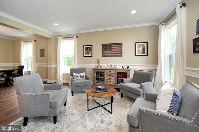 living room featuring wainscoting, recessed lighting, ornamental molding, and wood finished floors
