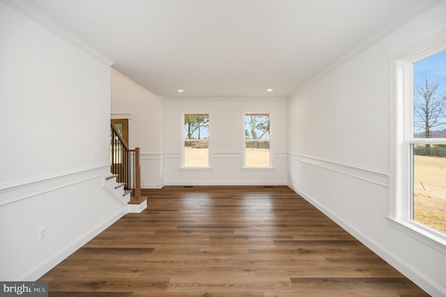 empty room featuring crown molding, recessed lighting, stairs, and wood finished floors