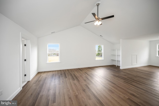 unfurnished living room featuring dark wood-type flooring, a ceiling fan, baseboards, and lofted ceiling