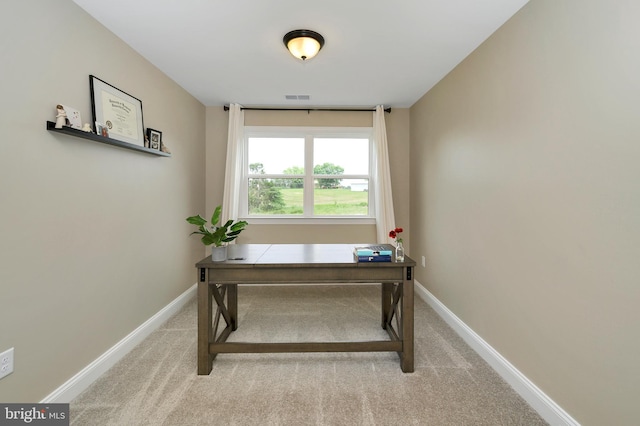 carpeted office space with baseboards and visible vents