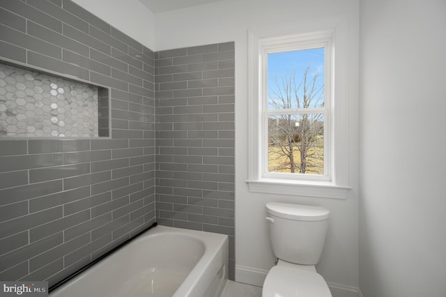 bathroom with baseboards and toilet