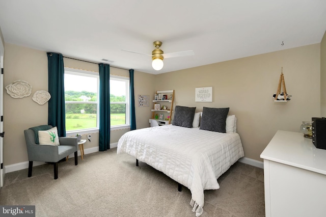 bedroom featuring baseboards, ceiling fan, light carpet, and visible vents