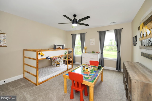 carpeted bedroom with baseboards, ceiling fan, and visible vents