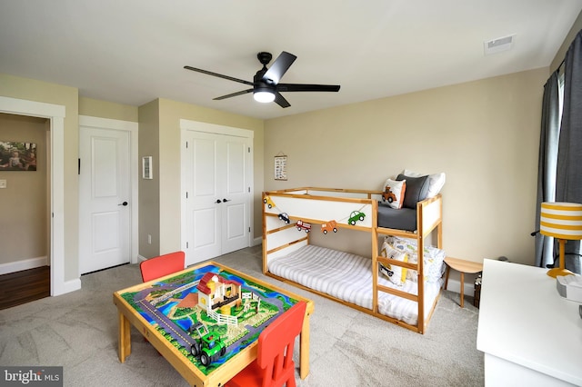 bedroom with visible vents, a closet, baseboards, ceiling fan, and carpet flooring