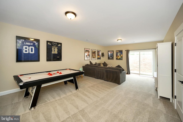 recreation room featuring baseboards and carpet