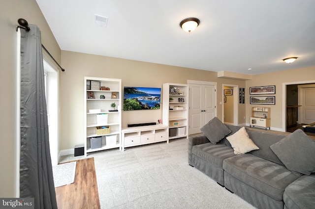 living room with baseboards and visible vents