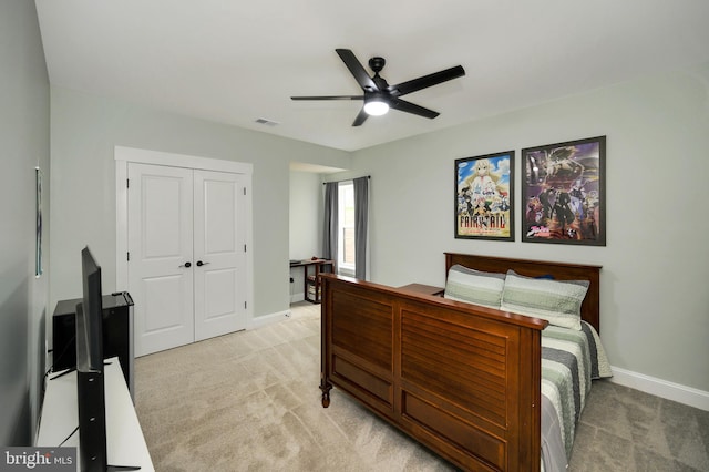 bedroom with visible vents, a closet, baseboards, light colored carpet, and a ceiling fan