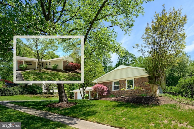 exterior space with brick siding and a front yard