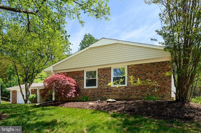 view of front of property featuring brick siding and a front yard