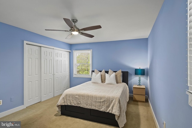 bedroom featuring baseboards, carpet, ceiling fan, and a closet
