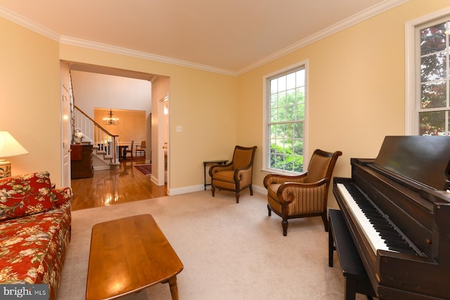 sitting room featuring stairs, ornamental molding, a chandelier, baseboards, and carpet flooring