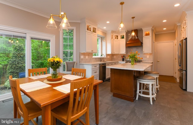 dining space with ornamental molding and recessed lighting