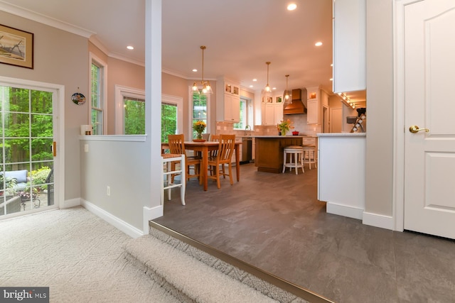dining area featuring recessed lighting, ornamental molding, baseboards, and healthy amount of natural light