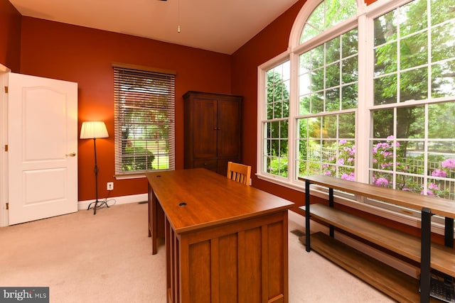 office featuring light carpet, baseboards, and ceiling fan
